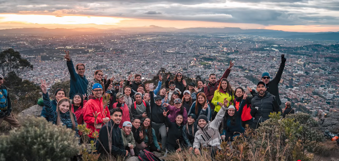 Atardecer en Bogotá con nubes rosadas sobre los cerros, fondo del club de solteros As de Corazones